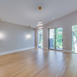 Master bedroom with modern light fixtures and white oak flooring