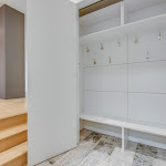 Custom closet in mud room with floor tiling