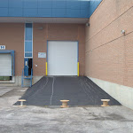 Gravel base added to create elevated entrance to reach completed industrial sized door