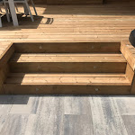 Wooden stairs leading up to deck with lights