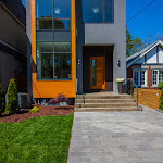 Front of house showing brown chip landscaping and stone interlocking