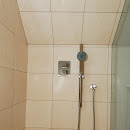 Large Walk in Shower on Third Floor Renovation showing new tiles and stainless steel shower head and faucets