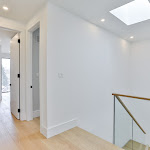 White oak engineered flooring in 2nd floor hallway with glass railings