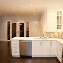 White kitchen cabinets create amazing contrast with Glass tiles backsplash  or Full view of renovated kitchen and living room area