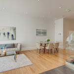 Living area along with dining room and white oak hardwood flooring