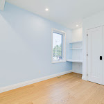 Bedroom with installed desk that looks out the window