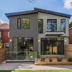 Back view of modern house with stone interlocking and wood patio