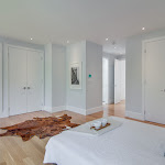 Master Bedroom with white oak hardwood flooring and white closet doors