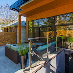 Walkout basement with glass railings and modern windows looking towards the backyard