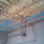 Foam insulation applied in between ceiling joist;
wall framing exposed too, for the foam application