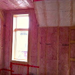 Insulation added to a room and around window frame