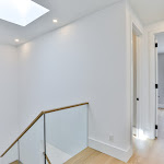 White oak engineered flooring in 2nd floor hallway with glass railings