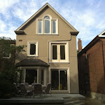 Front image of home with all new windows installed and stucco treatment