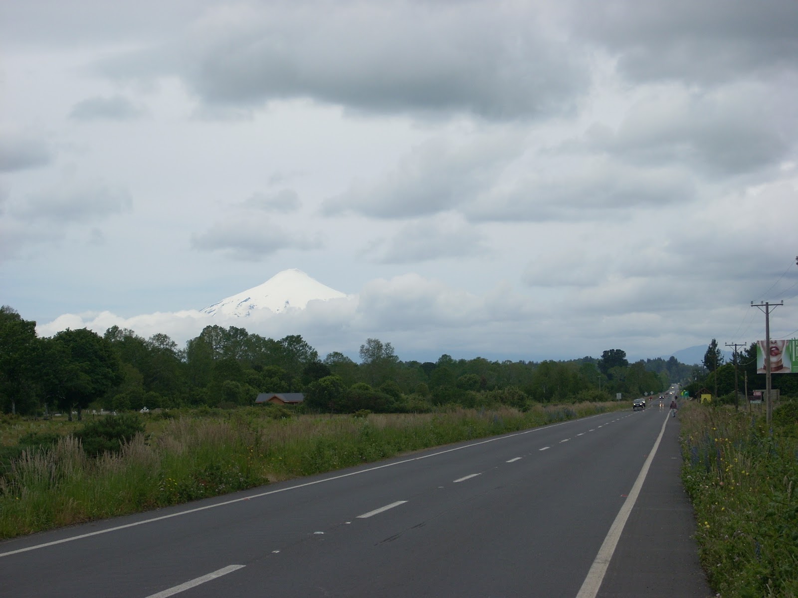 And onto this road. The last day of easy riding. Note the smooth shoulder. This will all just be a dream soon. The volcano is peeking through in the distance