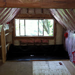 Before: Photo showing waterproof membrane, insulation, drywall, vapour barrier, framing and window installation