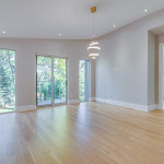 Master bedroom with 2 windows and glass sliding door looking out to the backyard