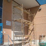 Scaffolding set up to begin removal of concrete wall for the exposed area