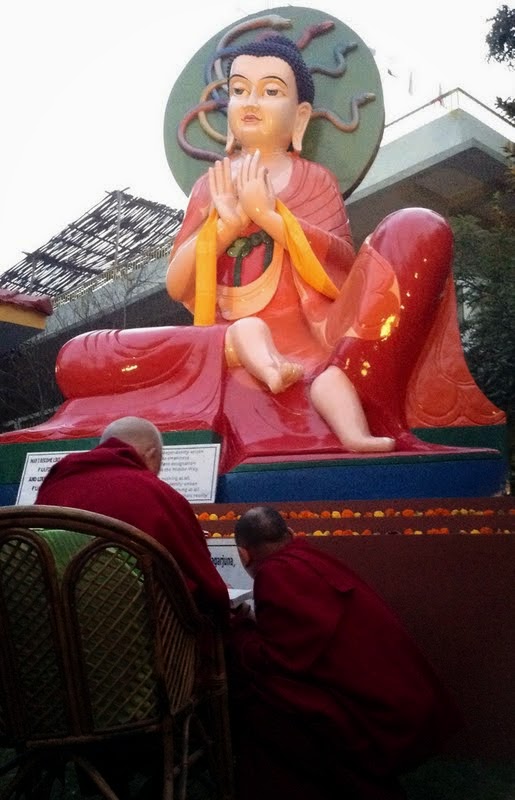 Lama Zopa Rinpoche reciting "Hymn to the World Transcendent One" by Nagarjuna. The Nagarjuna statue was built for Lama Zopa Rinpoche's long life a few years ago, Root Institute, Bodhgaya, India, February 2014. Photo by Ven. Sarah Thresher.