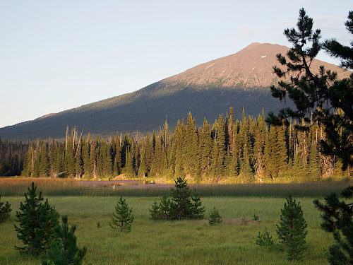 Kayaking on Hosmer Lake, near Bend, OR. Mt. Bachelor at sunset, viewed from our campground. Note the fly anglers fishing for the landlocked Atlantic Salmon in the clear, shallow water.