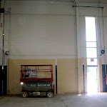 Area of industrial renovation where wall will be removed and large industrial door will be installed