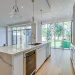 Modern kitchen with TCE stone quartz countertop and huge windows looking out to the backyard