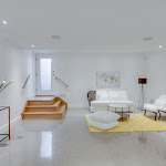 Polished concrete flooring in downstairs living space with walkout basement door