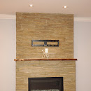 Modern fireplace sorraunded with stone tilesc