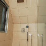 Large Walk in Shower showing Steel Modern Shower Head and Faucets