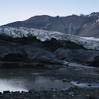 The glacier looks dirty because of the black lava sand