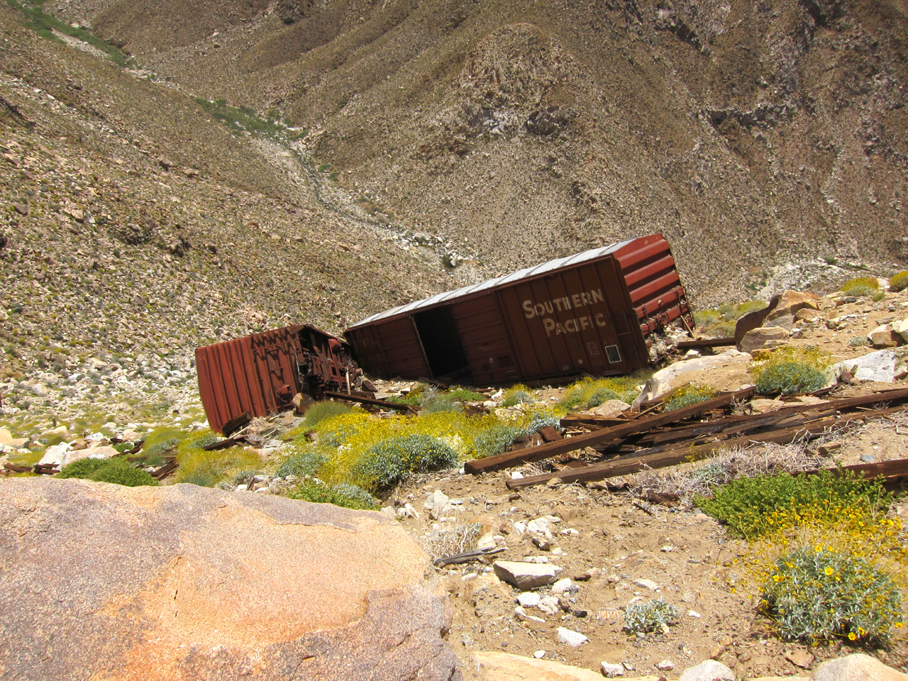 Old box cars that were apparently pushed off the mountain