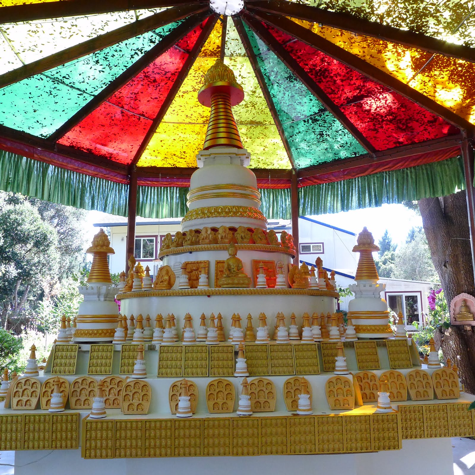 Kadampa stupa with many other stupas and tsa tsas at Kachoe Dechen Ling,  Aptos, CA, USA.