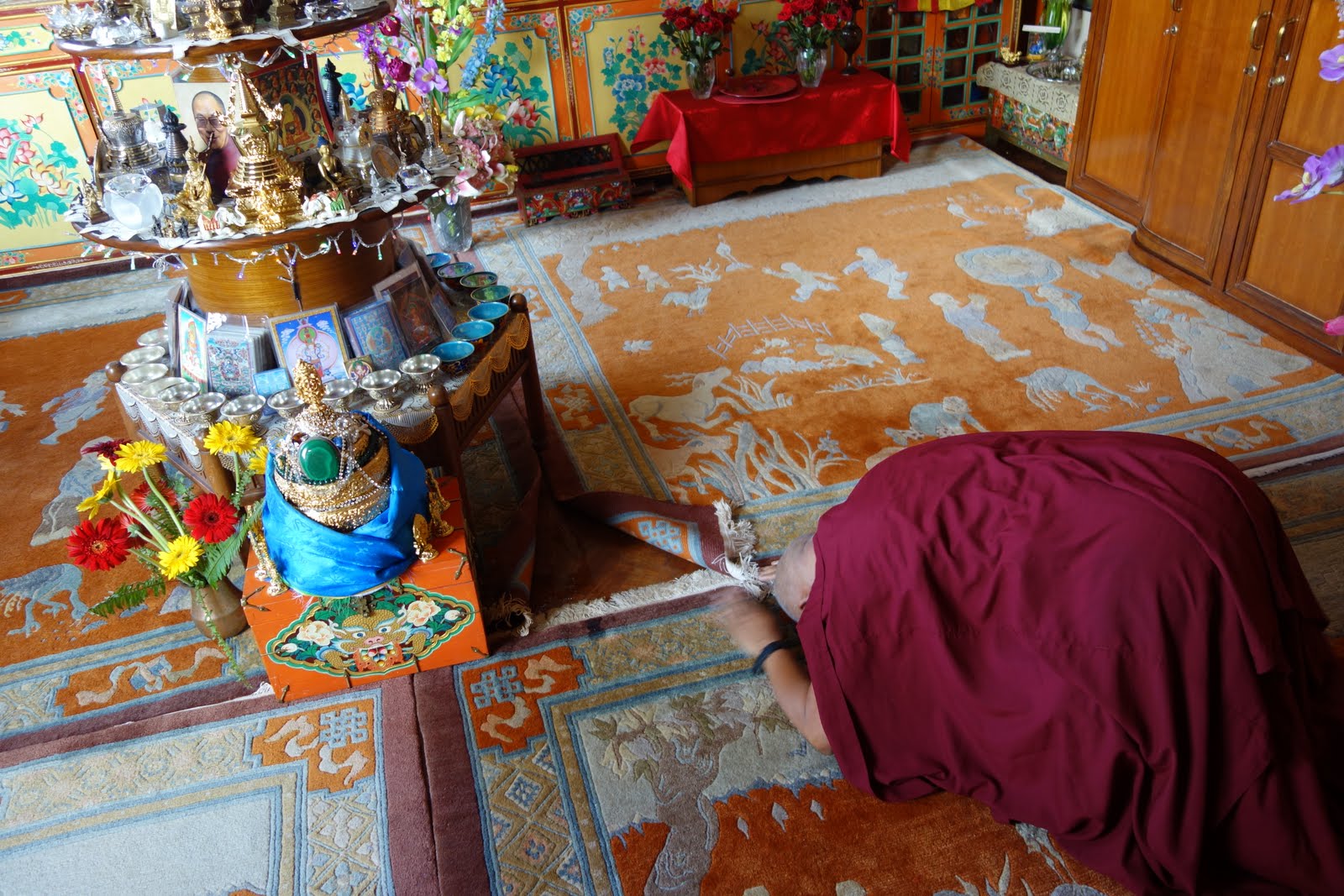 First thing in the morning, Rinpoche is doing prostrations to the altar in his room. There is one altar that has many holy relics on it and Rinpoche circumambulates it every day. Rinpoche is making a very quick stop here on the way to Mongolia. Aug 10, 2013.