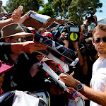 Jenson Button signs autographs for fans