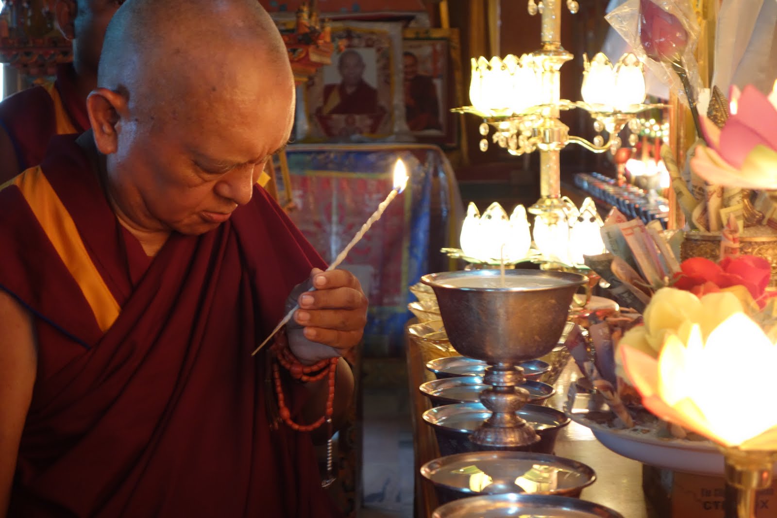 Rinpoche offering butter lamp. August 8, 2013 Photo: Ven. Roger Kunsang