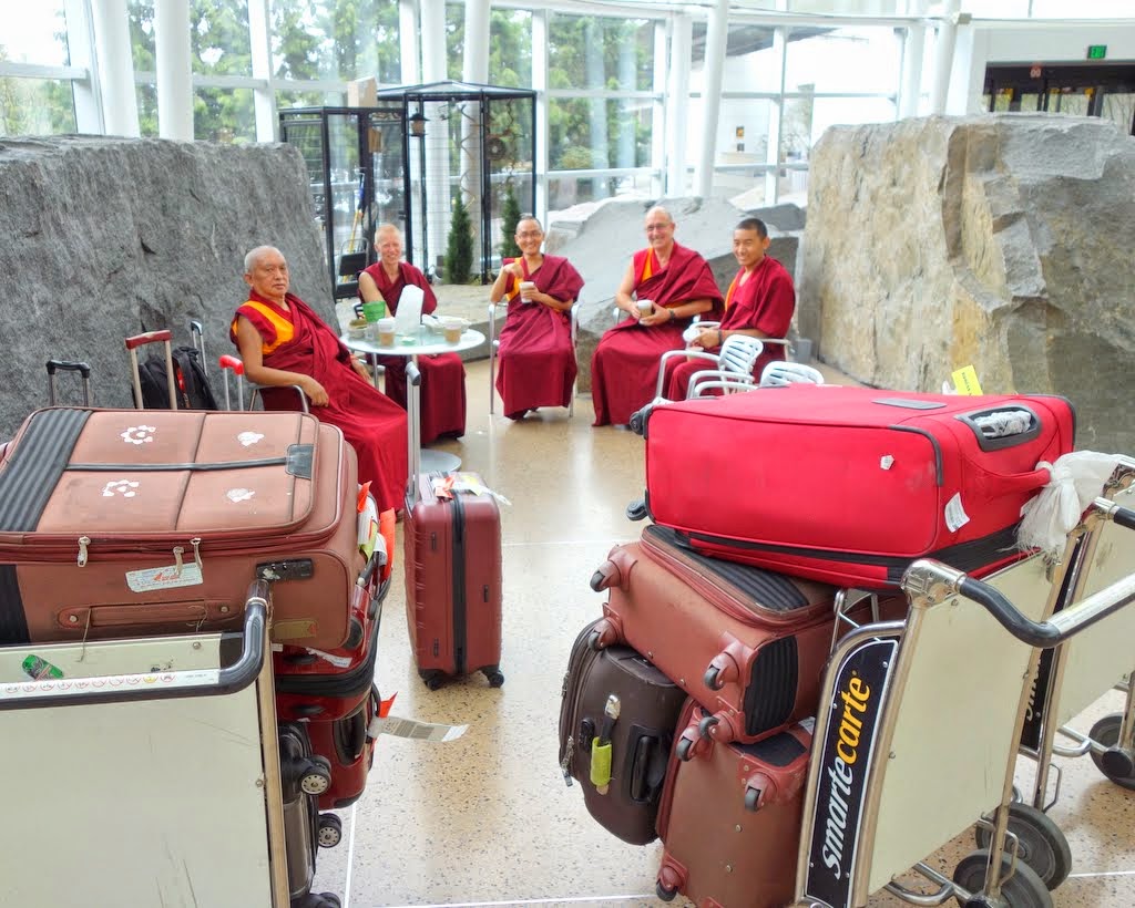Lama Zopa Rinpoche with Vens. Holly Ansett, Sherab, Kunsang and Sangpo and luggage, after arriving in the United States from Taiwan, SeaTac Airport, Washington, April 2014. Photo by Ven. Roger Kunsang. Ven. Holly drove up from California to meet Rinpoche and his entourage at the airport.