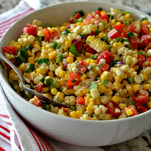 This delectable corn salad brings it all together with fresh corn, sweet red bell peppers, sun ripened tomatoes, cilantro, minced jalapeno, chopped scallions and feta cheese all in a lightly sweetened lime vinaigrette. 