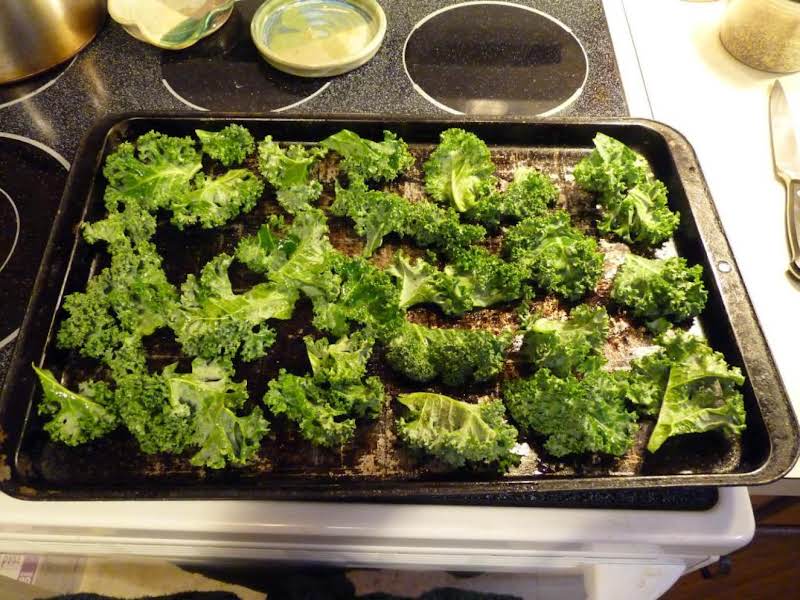 Two Leaves Of Kale, Cut Into Pieces And Seasoned. Ready For The Oven.