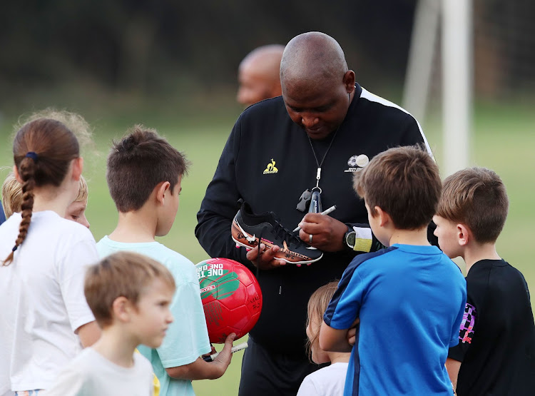 South Africa's Cosafa Cup coach Morena Ramoreboli sign autographs during a training session at Virginia Sports Club in Durban on July 4 2023.