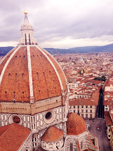 View from the Bell Tower of the Duomo (including tourists at the top) and surrounding cityscape in Florence.