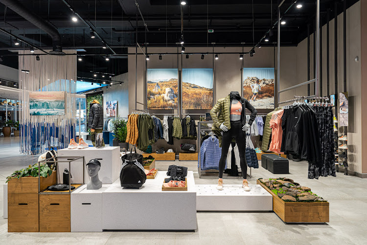 Posters of the natural landscapes to be found in and around Johannesburg hang in the Adidas flagship store in Sandton City. Natural elements like moss and rock samples foraged from nearby green spaces are used as props in store.