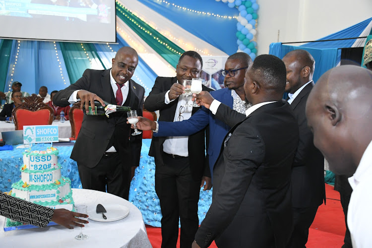 Shofco Sacco leadership cutting a cake to celebrate the launch of lender's digital platforms that will aid seamless banking for its customers.