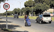 daily struggle:
       Memesi Pholwane pushes 
      
       her son, Karabo, 
      
       15, who is wheelchair-bound and  mentally disabled
      
       to catch the bus to school  
      PHOTO:  Baleseng Mosotho