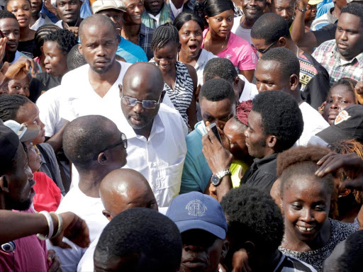 George Weah, former soccer player and presidential candidate of Congress for Democratic Change (CDC), arrives for his presidential election vote in Monrovia, Liberia, October 10, 2017. /REUTERS