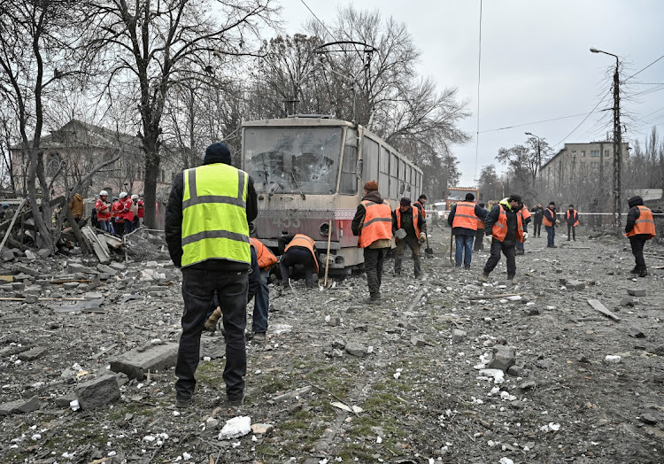 Communal workers gather at the site of a Russian missile strike, amid Russia's attack on Ukraine, in Zaporizhzhia, Ukraine, on December 29 2023.