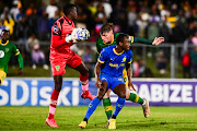 Lamontville Golden Arrows goalkeeper Ismail Watenga collects while teammate Bradley Cross challenges Peter Shalulile of Mamelodi Sundowns in the DStv Premiership match at Mpumalanga Stadium in Hammarsdale on Wednesday night.