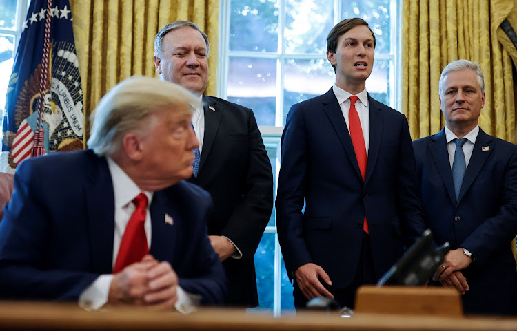 US President Donald Trump listens with Secretary of State Mike Pompeo and National Security adviser Robert O'Brien as White House senior adviser Jared Kushner speaks about an agreement between Israel and Sudan on steps toward normalization of relations in the Oval Office at the White House in Washington, US, October 23, 2020.