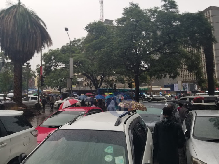 Motorists brave Nairobi rainfall to go about their business on March 23, 2023.