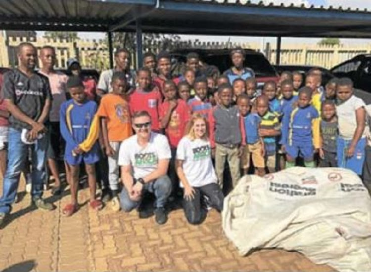 Gavin Hendry and Sarah Gardner collect used soccer boots from across the globe to donate to the needy.