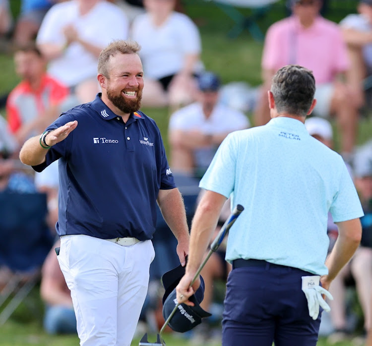Shane Lowry of Ireland and Justin Rose of England embrace on the 18th green after Lowry carded a 62 in the the third round of the 2024 PGA Championship at Valhalla Golf Club in Louisville, Kentucky on Saturday.