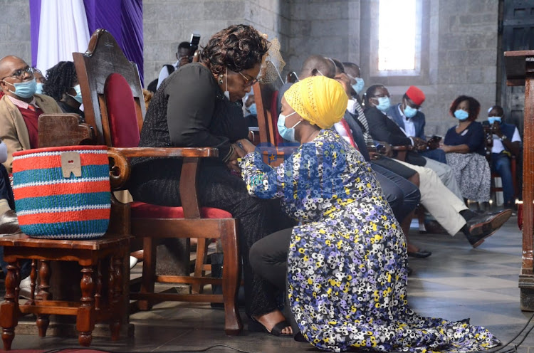 Justus Murunga's second wife Christabel Murunga is consoled by a relative after giving her tribute at St Stephens Church, Nairobi on December 3, 2020.